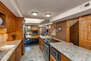 Fully Equipped Kitchen with Stainless Steel Appliances, Granite Countertops, and Bar Seating for 4