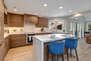 Gourmet Kitchen with a Center Island Seating and Beautiful Marbled Countertops