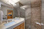 Main Level Shared Full Bathroom with a Quartz Counter Sink and Large Tiled Shower