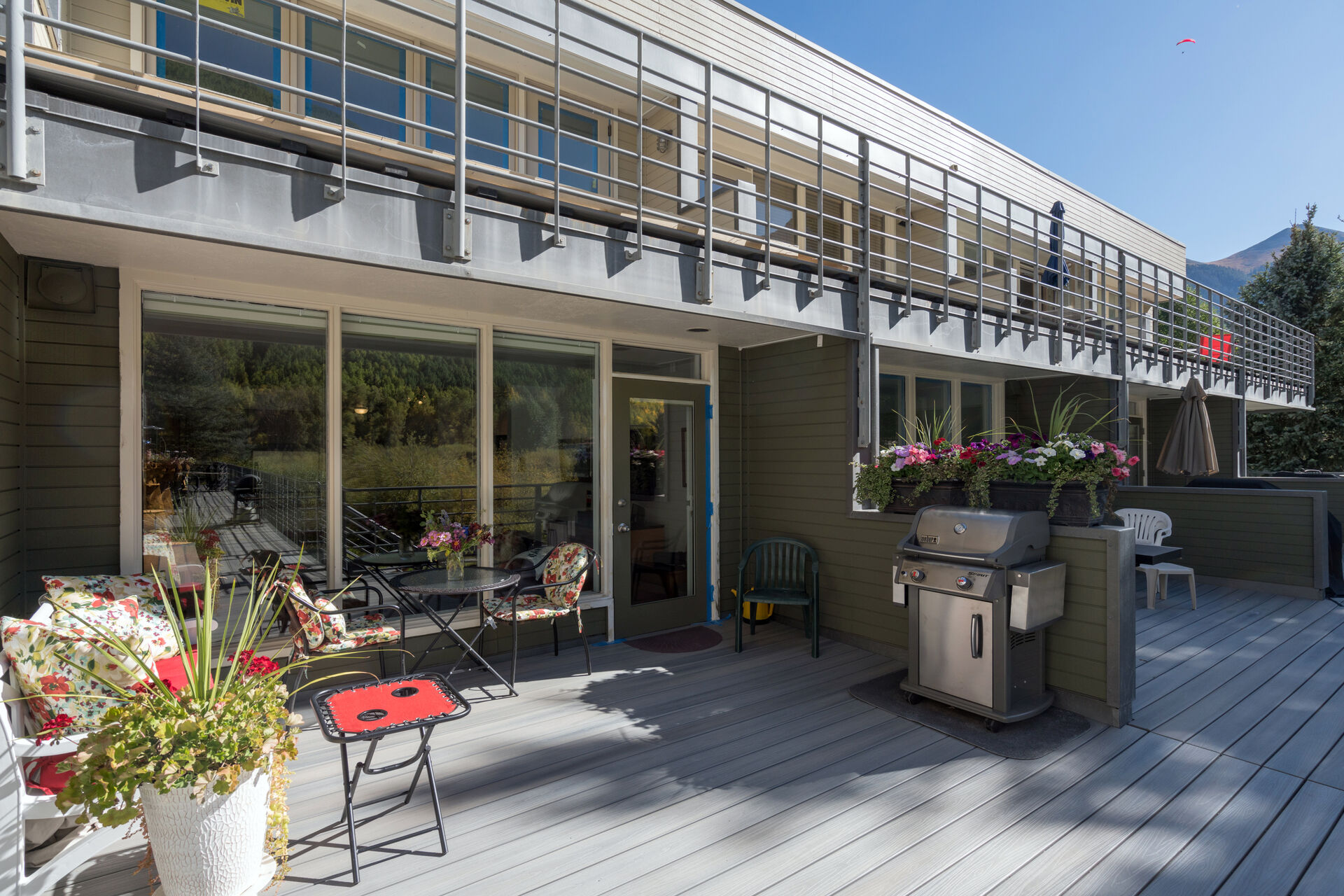 An external view of this Telluride condo, showing the deck with grill and seating.