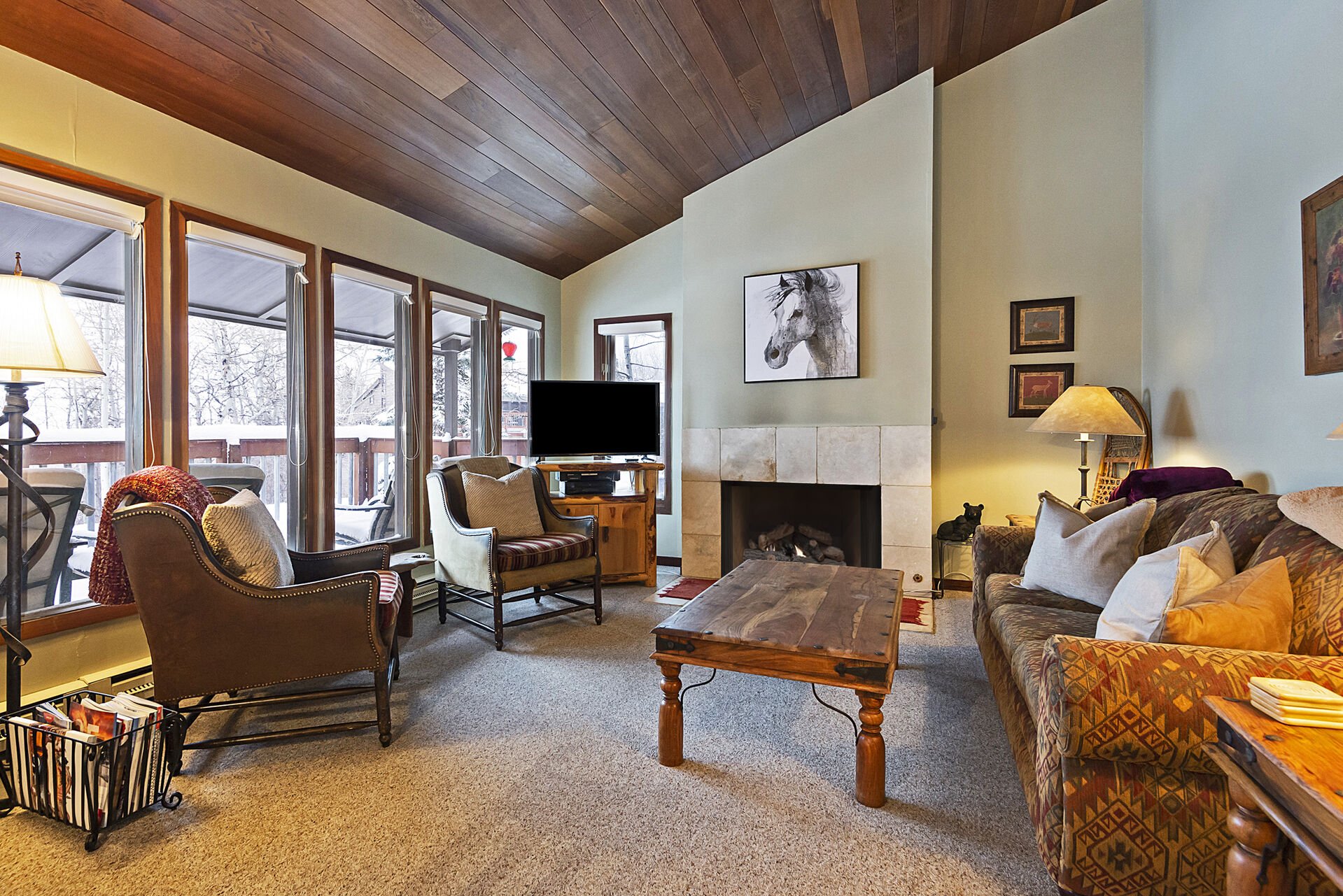 Cozy Living Room with a Gas Fireplace, Smart TV and Plenty of Windows to Bring in the Natural Light
