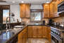 Fully Equipped Kitchen with Stainless Steel Appliances, Including a Thermador 4-Burner Gas Range, and Granite Countertops