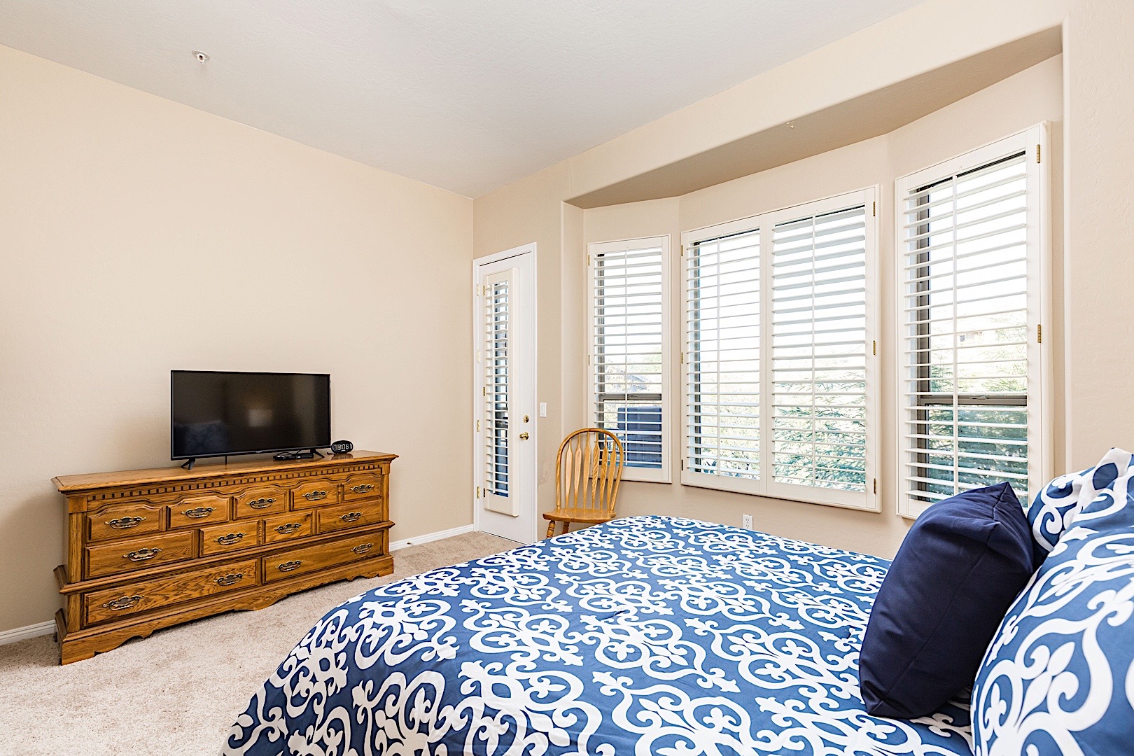 Master bedroom- Flat screen TV with cable and access to upper level patio with a KING bed.