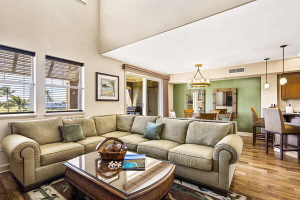 Spacious & open floor plan pf the living area of this Kona Hawaii vacation rental, with secitonal couch and coffee table.