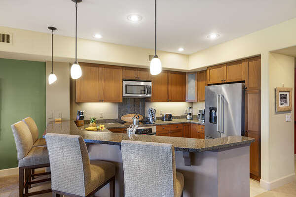 Fully equipped kitchen with breakfast bar and seating for 4.