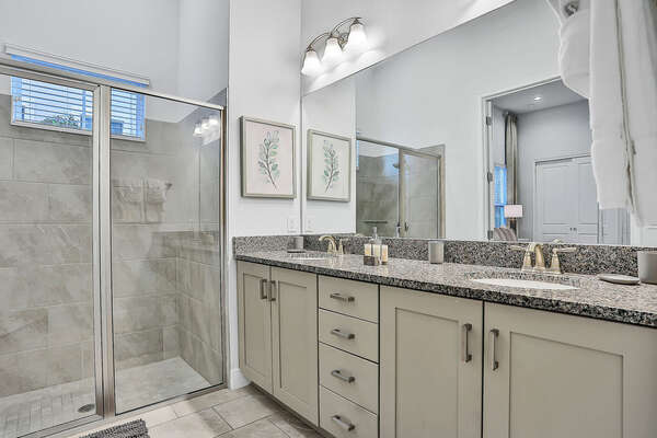 The en suite bathroom features a double vanity and walk-in shower