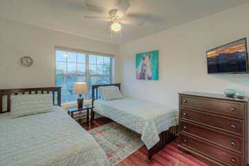 Bedroom 3 has 2 extra long twin beds, a ceiling fan and TV.