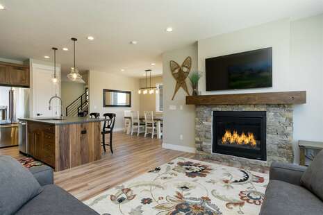 Main floor living room with fireplace and TV