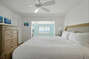 Bedroom with King Bed and Ceiling Fan This Bedroom Has a Fantastic Coastal View