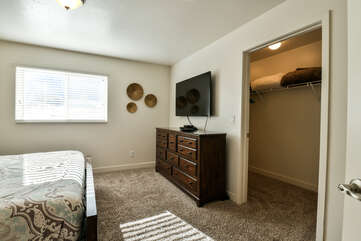Master bedroom with a flat-screen TV and a closet