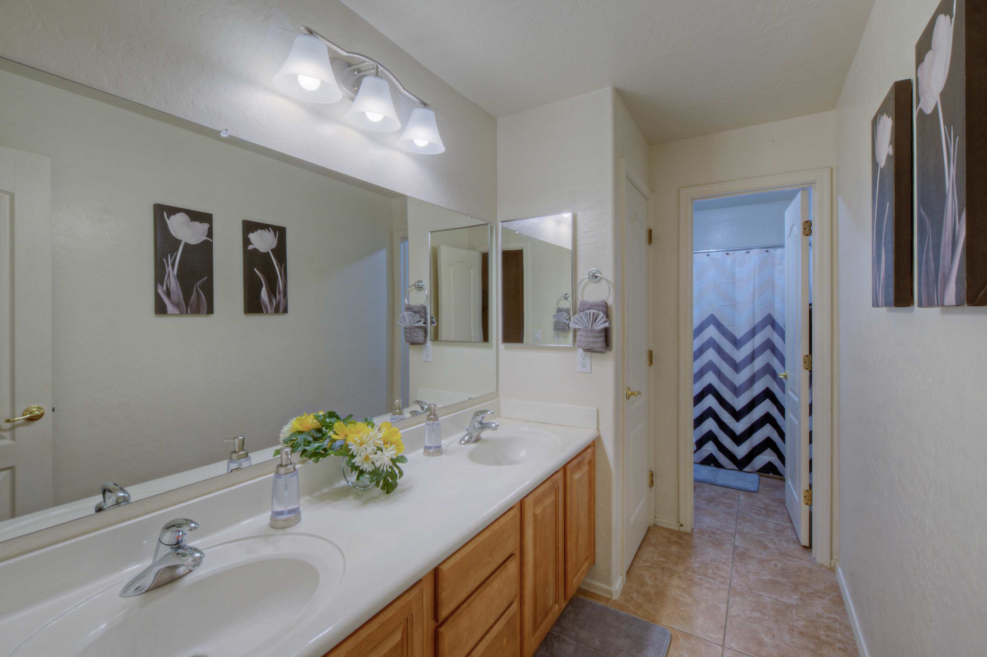 Second bathroom with dual vanity sinks is on the second floor and shared between second and third bedrooms.