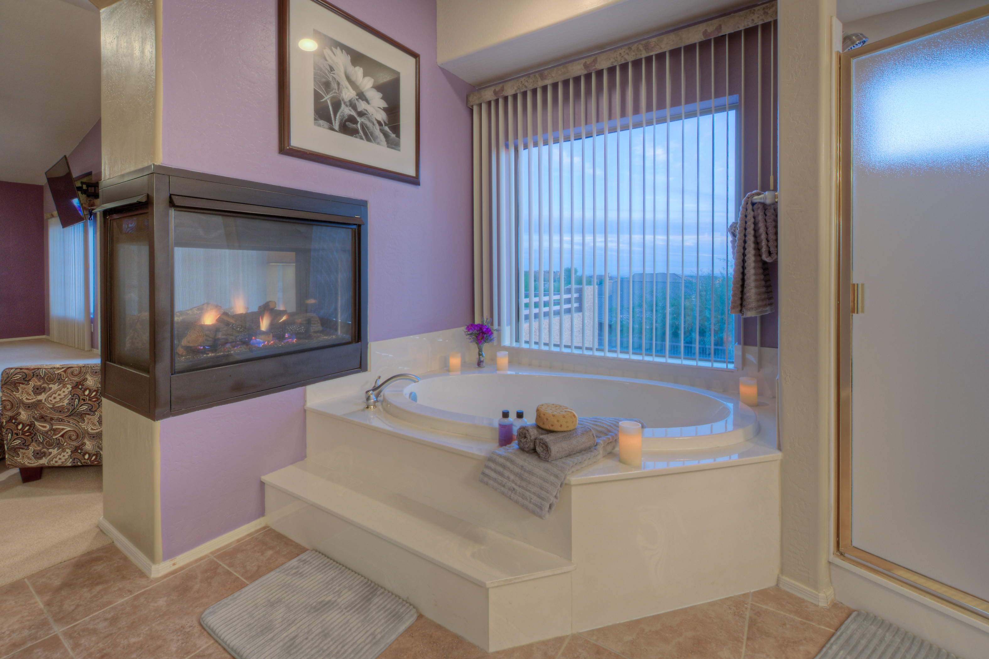 Ensuite primary bath has a double sided fireplace and sumptuous garden tub.