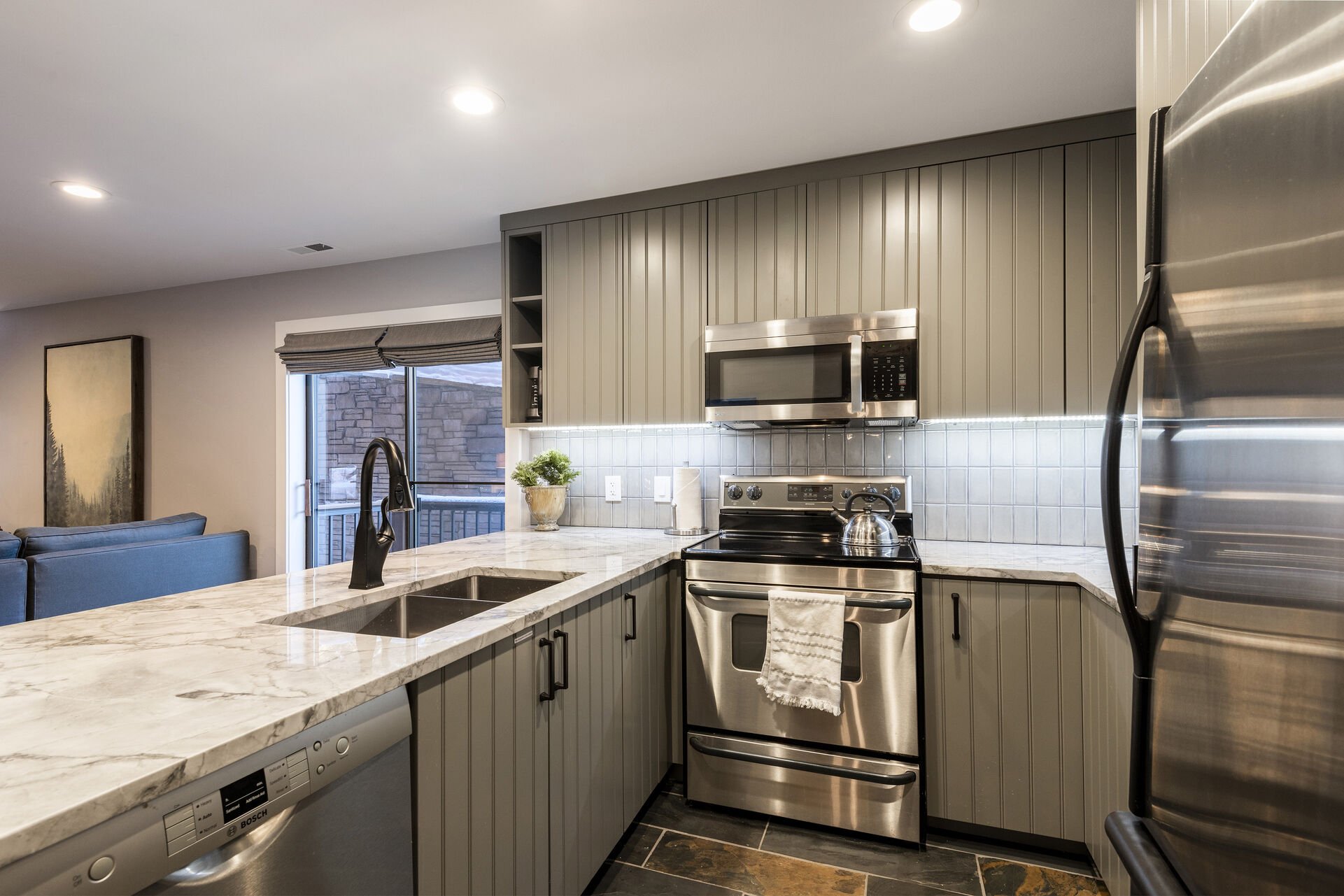 Remodeled Kitchen with Stainless Steel Appliances, and Ample Quartz Countertops for Meal Prep and Entertaining