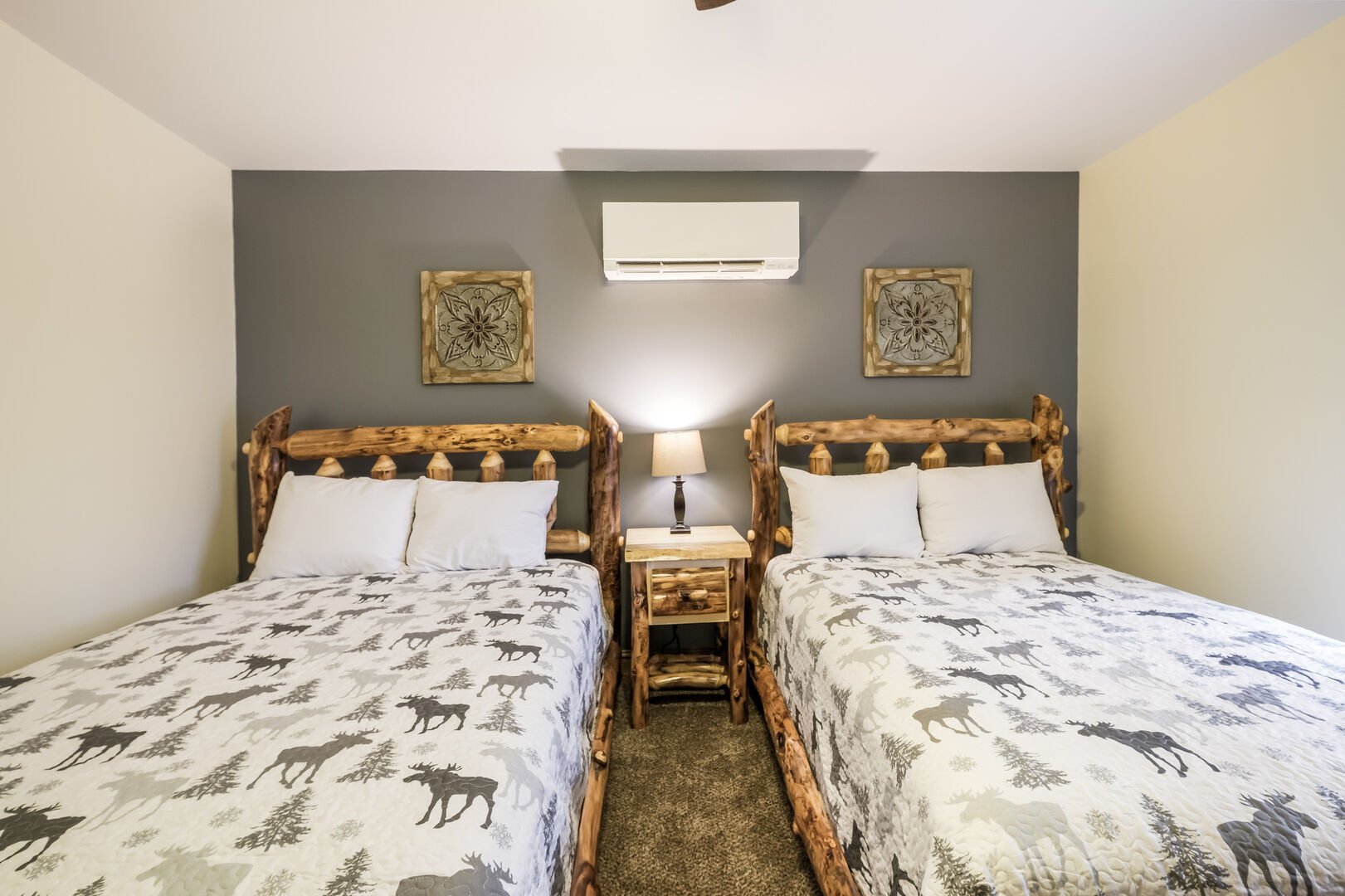 Bedroom Featuring Matching Beds with Moose Pattern Linens