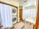 The bathroom has new washer and dryer along with a shower/tub combination.