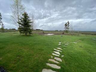 From the outside there is a stone path to take in the beautiful scenery of the cabin.