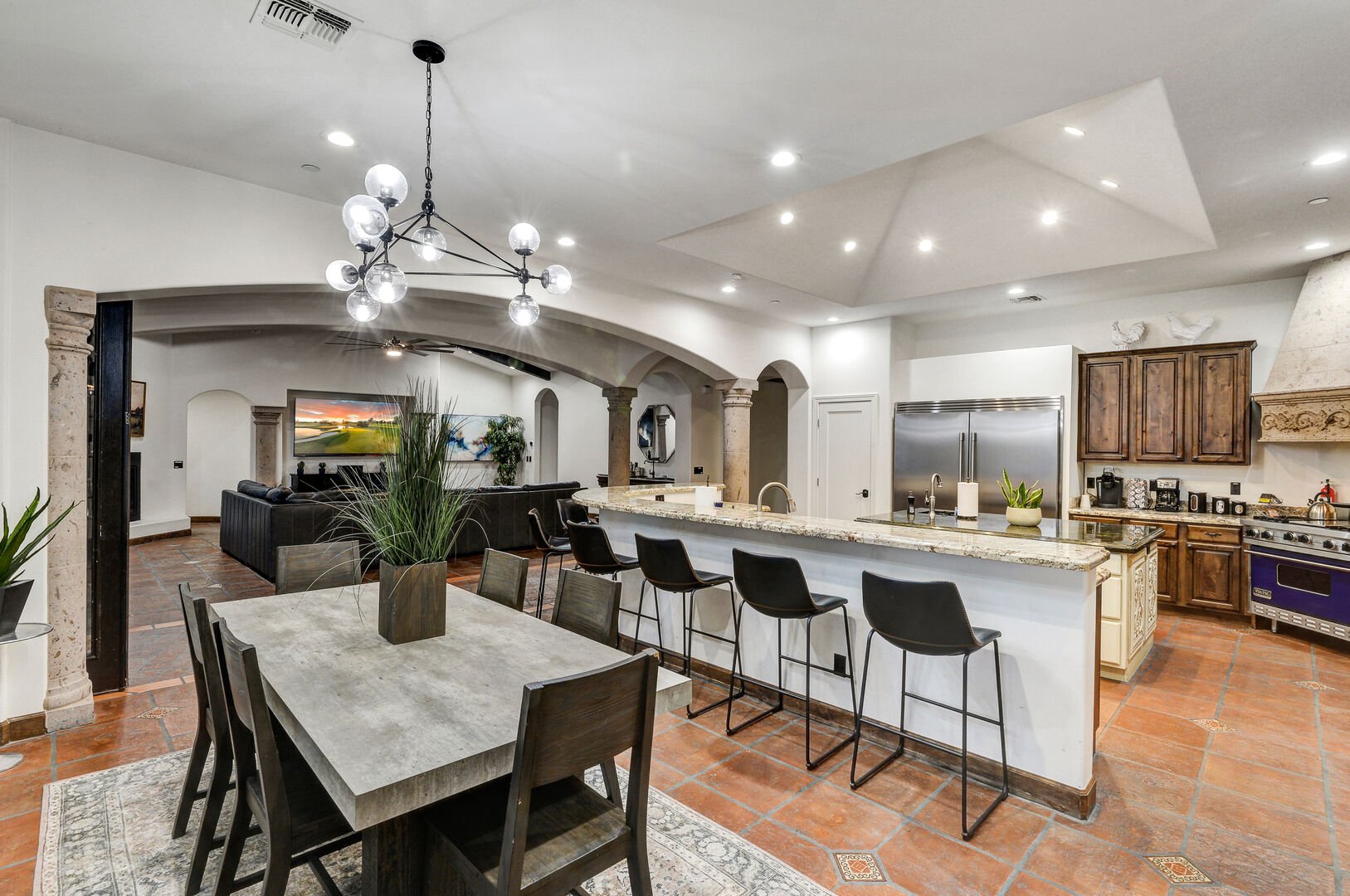 Experience the perfect harmony of the kitchen, dining room, and living room in Casa Palacio.