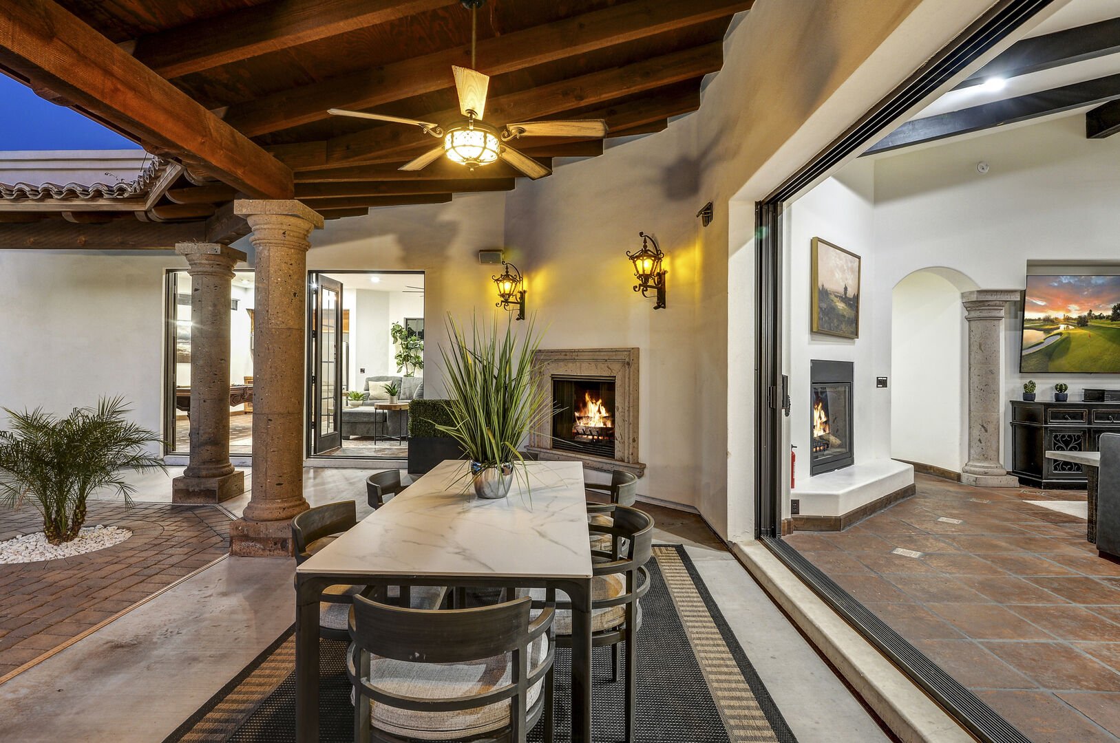 The covered patio at Casa Palacio offers a seamless connection to the living room. This design invites guests to enjoy the best of both worlds, with a sheltered outdoor space providing a tranquil extension of the inviting living room.