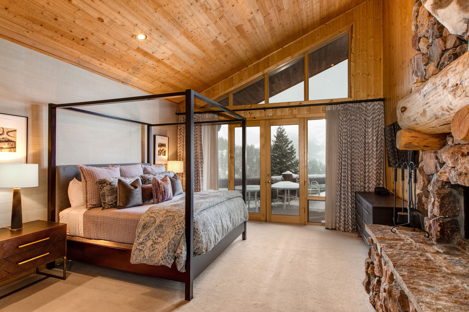 Main Level Grand Master Bedroom with a King Bed, Floor-to-Ceiling Windows, and Deck Access