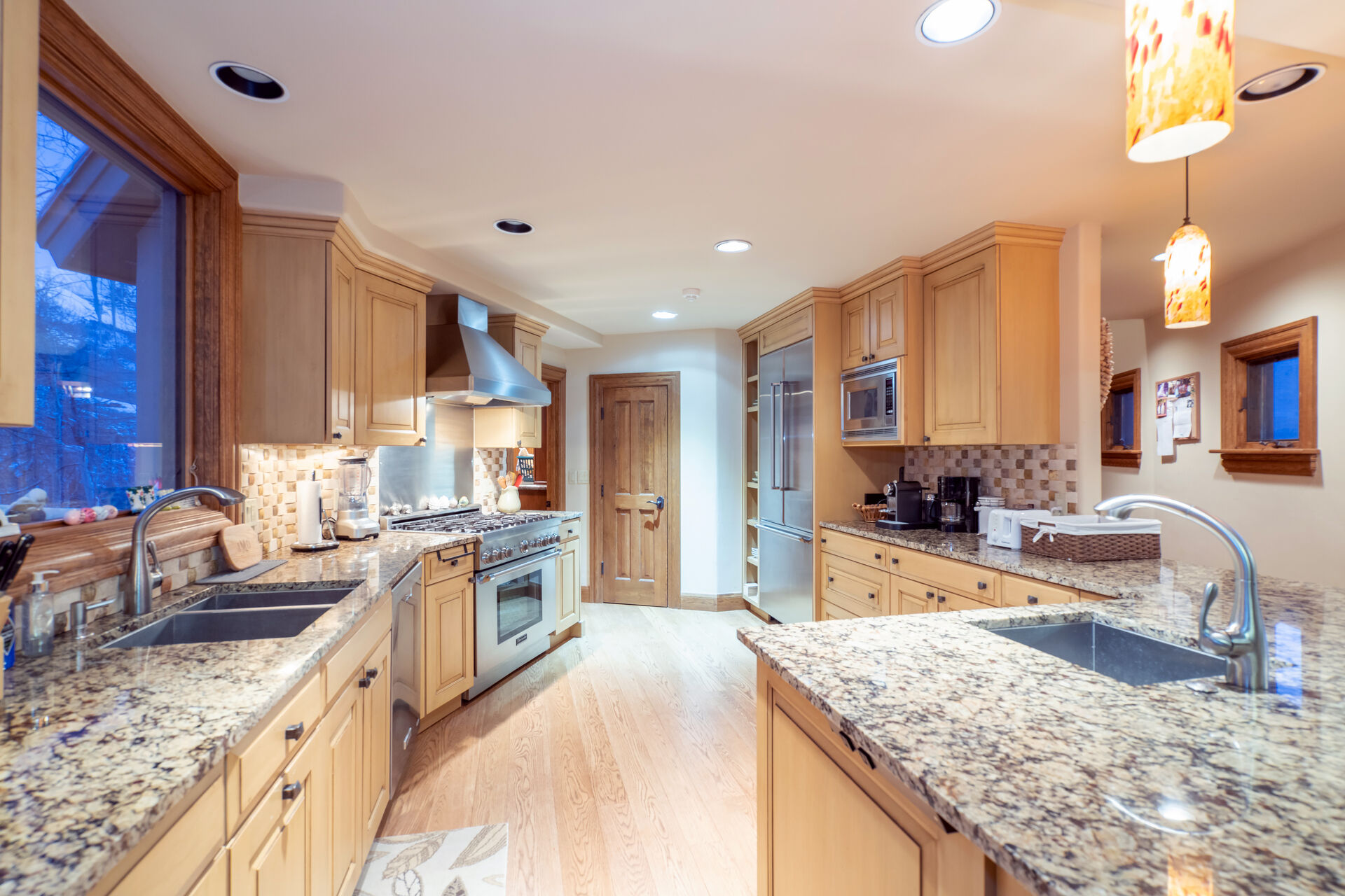 The kitchen of this Telluride golf rental, with two sinks and stainless steel appliances.