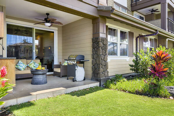 External view of the porch of this Hali'i Kai condo, displaying the grill and seating.