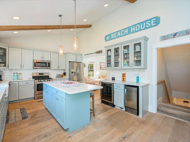 Kitchen center island  with seating and wet bar and door to finished basement-58 Depot St, Dennisport, New England Vacation Rentals