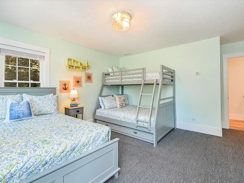Bedroom # 2 - has a combo bunk bed / trundle with full under and twin on top, trundle pulls out to a twin bed. and  additional full size bed, with carpet throughout.  58 Depot St, Dennisport , New England Vacation Rentals