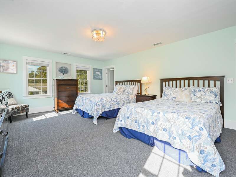 Bed room #3- This very spacious costal accented room has carpeted throughout and has 2 queen size beds , entrance to attic room with additional sleeps is at the back of this room.  58 Depot St, Dennisport , New England Vacation Rentals