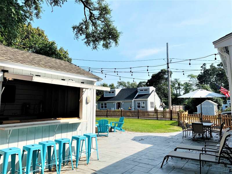 Outside entertainment area with Tiki bar, fire pit, patio furniture- 58 Depot St, Dennisport , New England Vacation Rentals