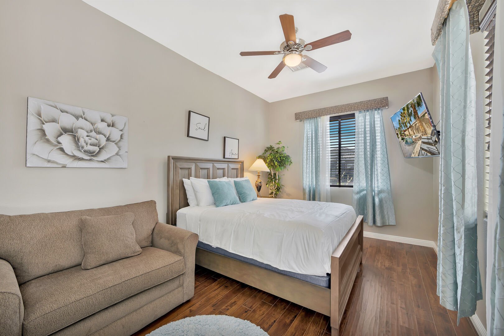 Casita Suite 3 features a Full-sized bed, Twin-Sized Sofa Sleeper, 55-inch TCL Smart Television, and ceiling fan.