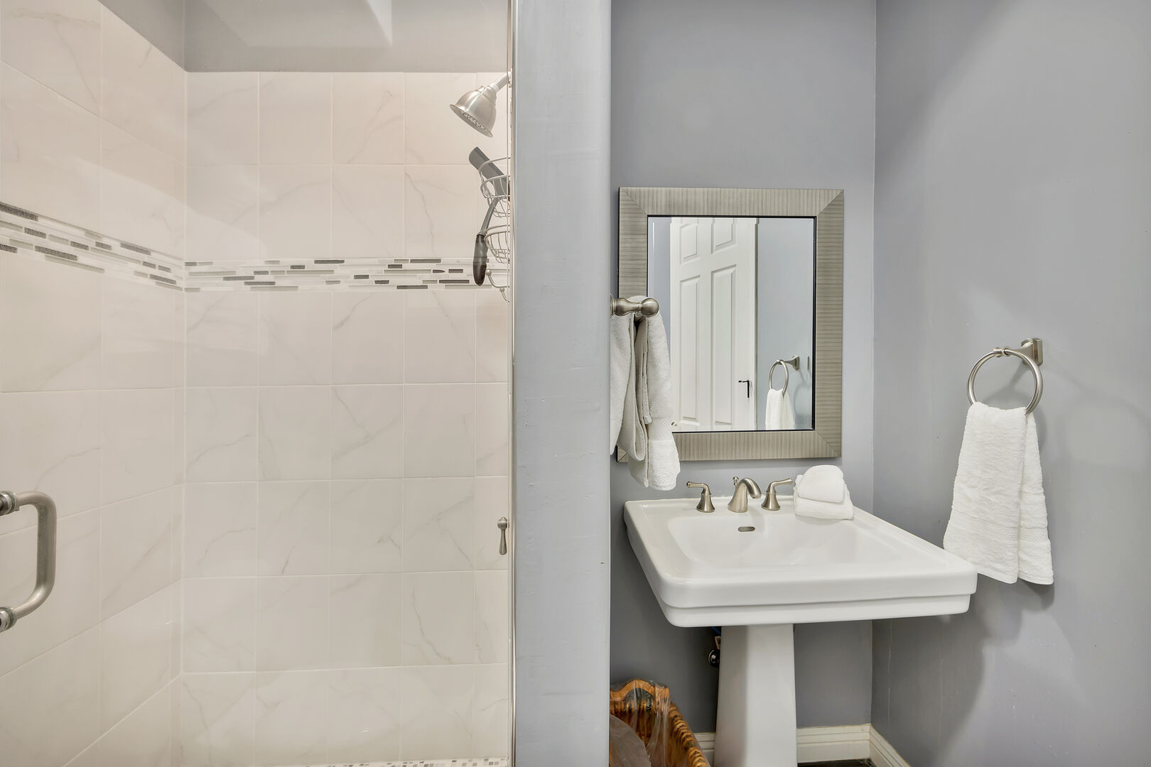 Casita Suite 3 private, en suite bathroom features a tile shower and a pedestal sink.