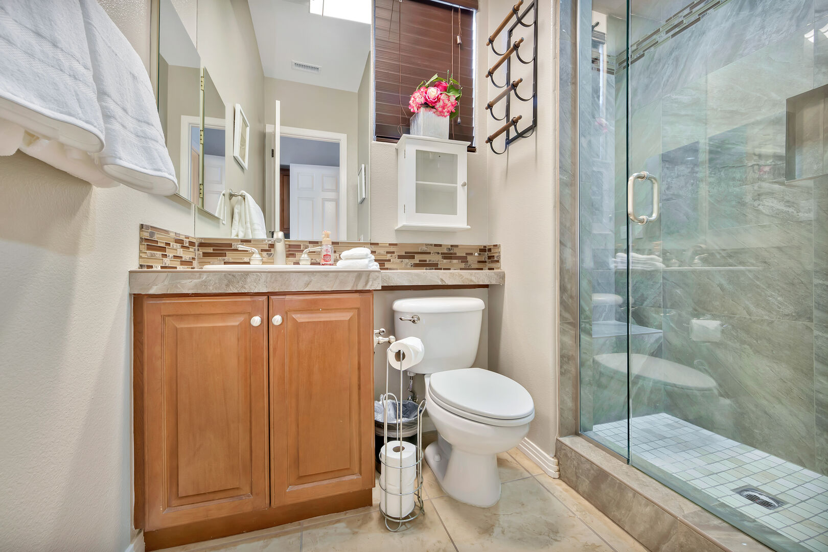 Suite 2 private, en suite bathroom features a tile shower and double vanity sinks.