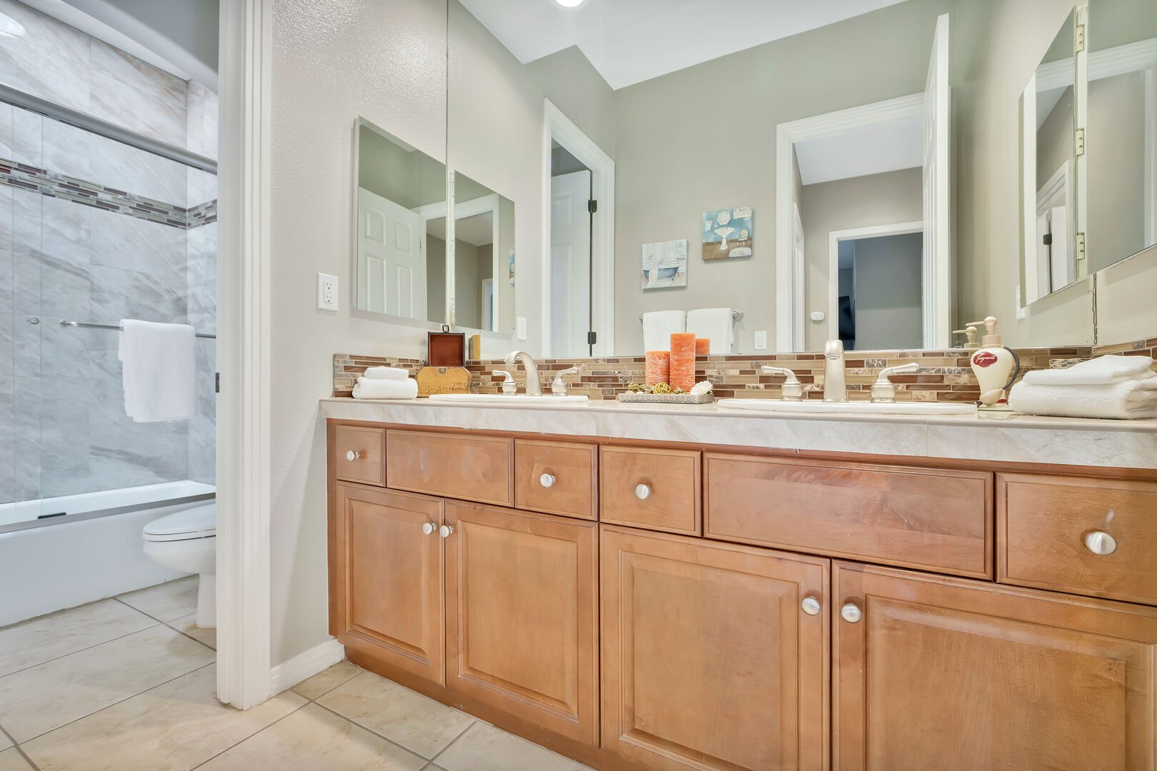 The hallway bathroom 4 is located next to the Laundry Room and features a shower bathtub combo and double vanity sinks.