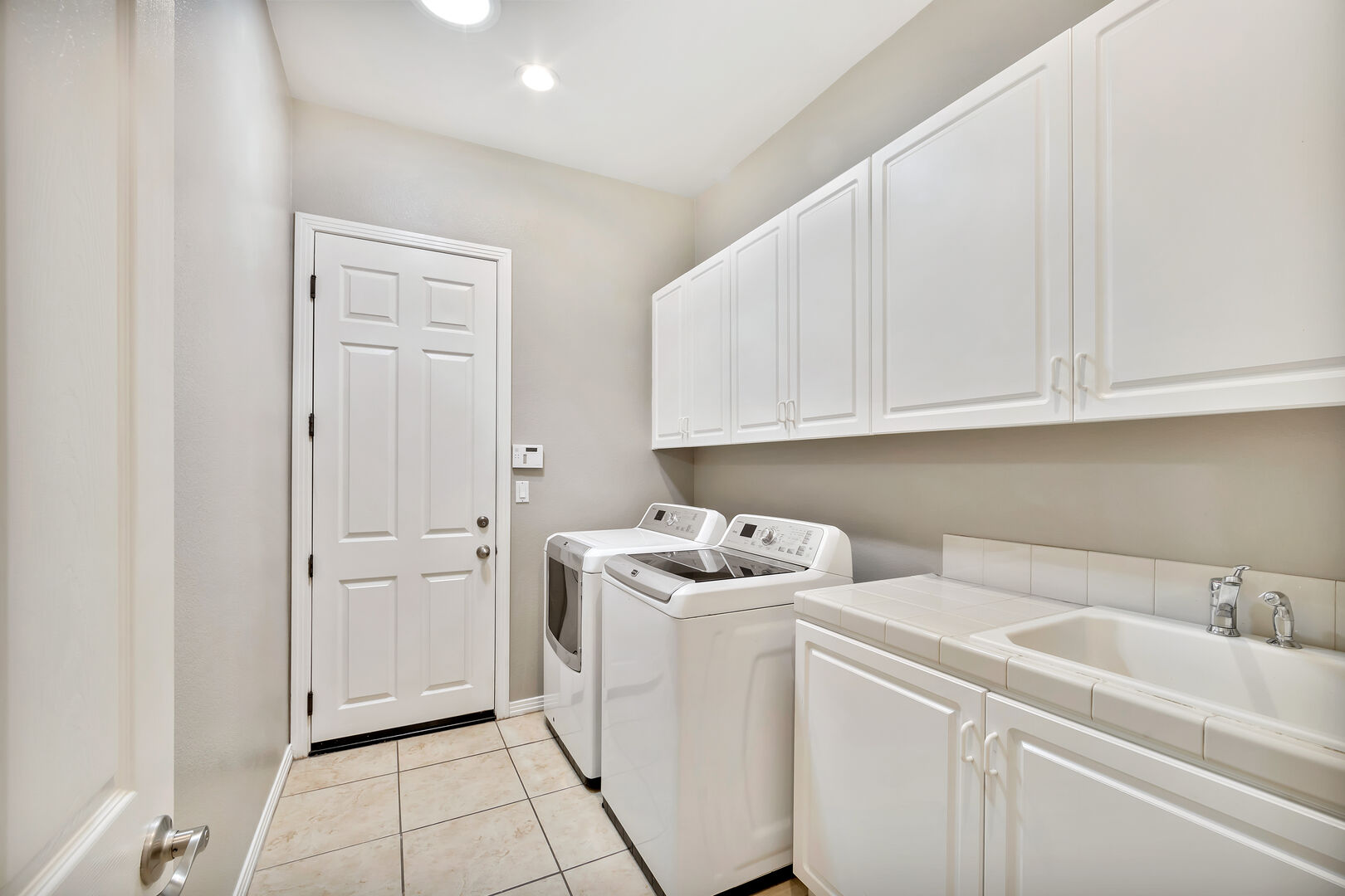 Laundry room features a sink to help keep your clothes clean. Travel home with clean clothes!