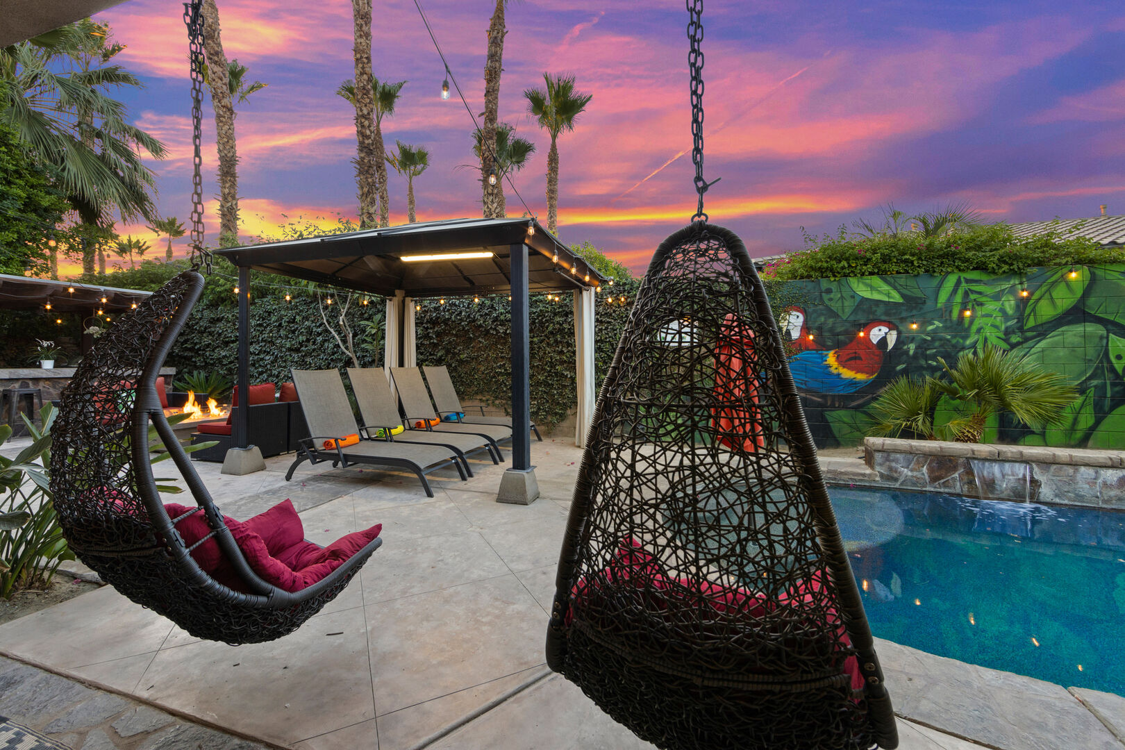This covered lighted gazebo and hanging chairs are sure to be the favorite spot for lounging.