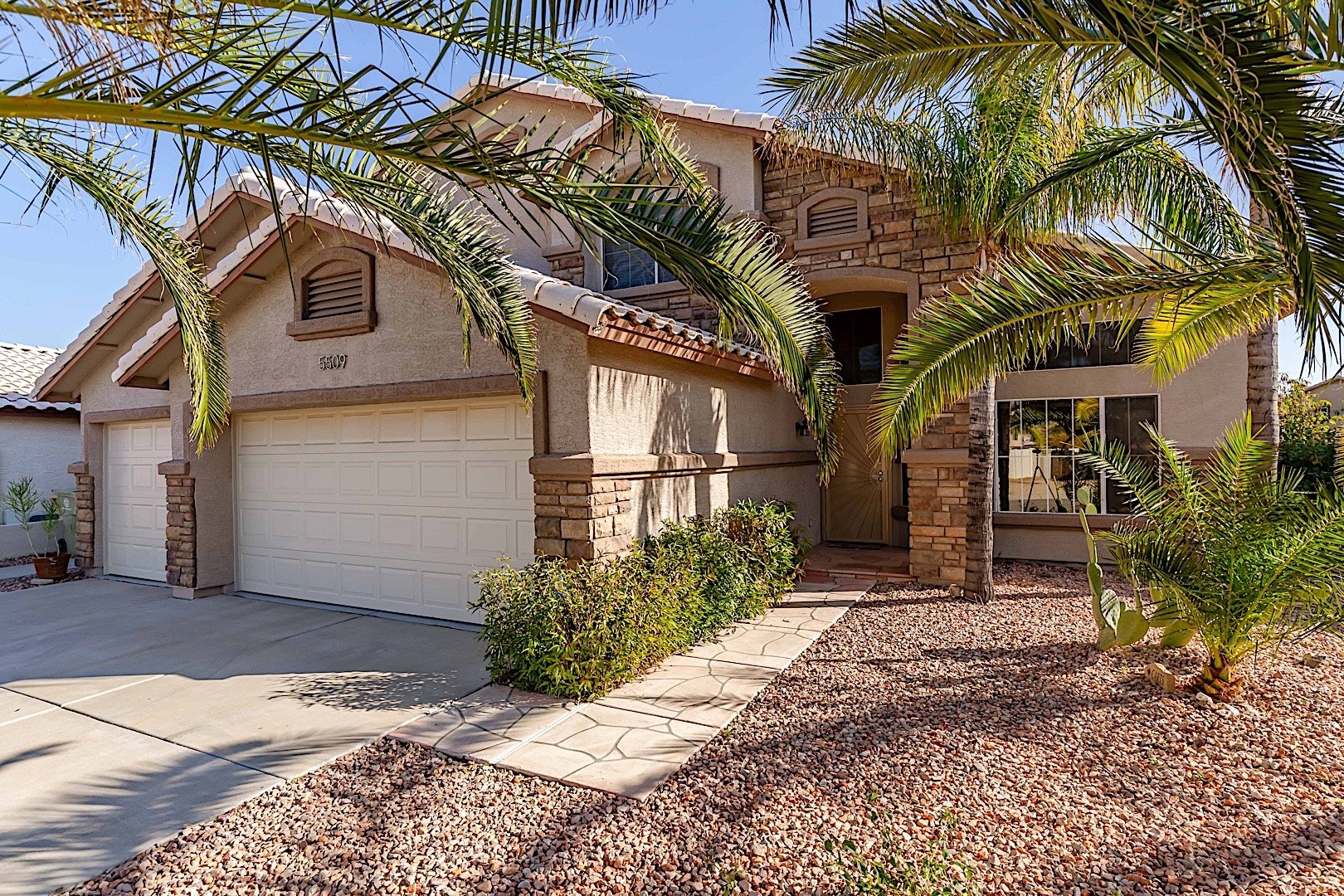 Step into the world of tropical palm trees on Piute Dr.