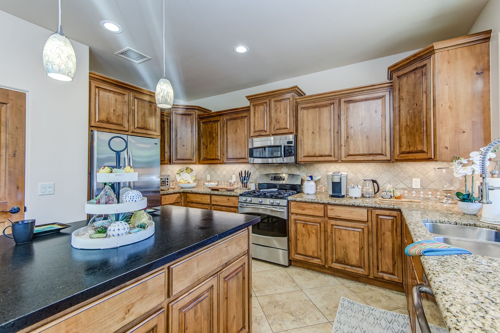 Spacious and Fully Equipped Kitchen Featuring Alder Wood Cabinets and Granite Counters