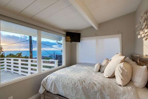 Bedroom with Large Bed, Private Balcony, and TV.