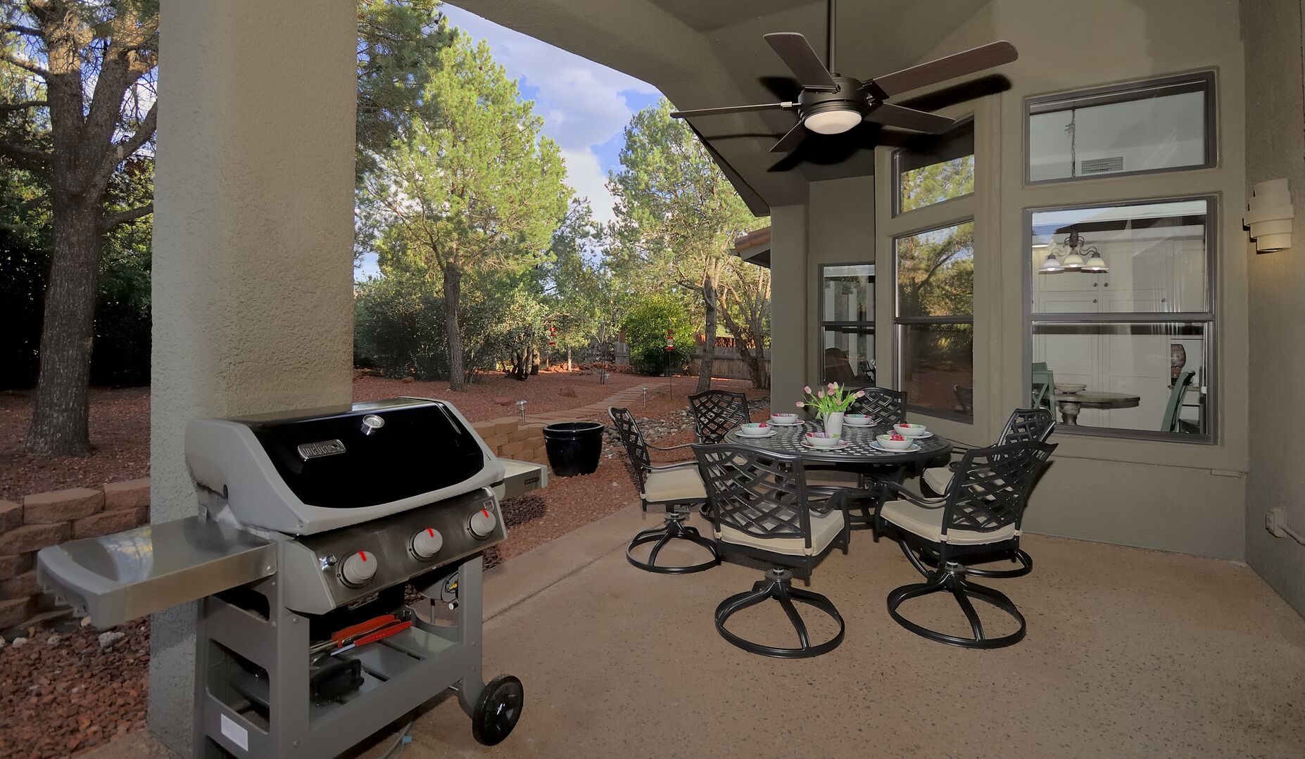 Covered outdoor dining and a gas grill