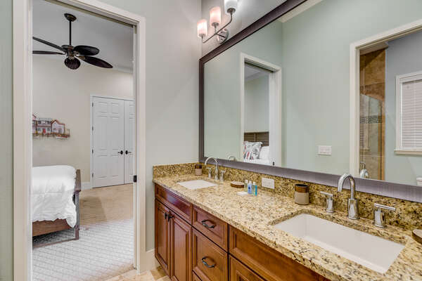 Jack and Jill bathroom has a dual vanity and a walk in shower