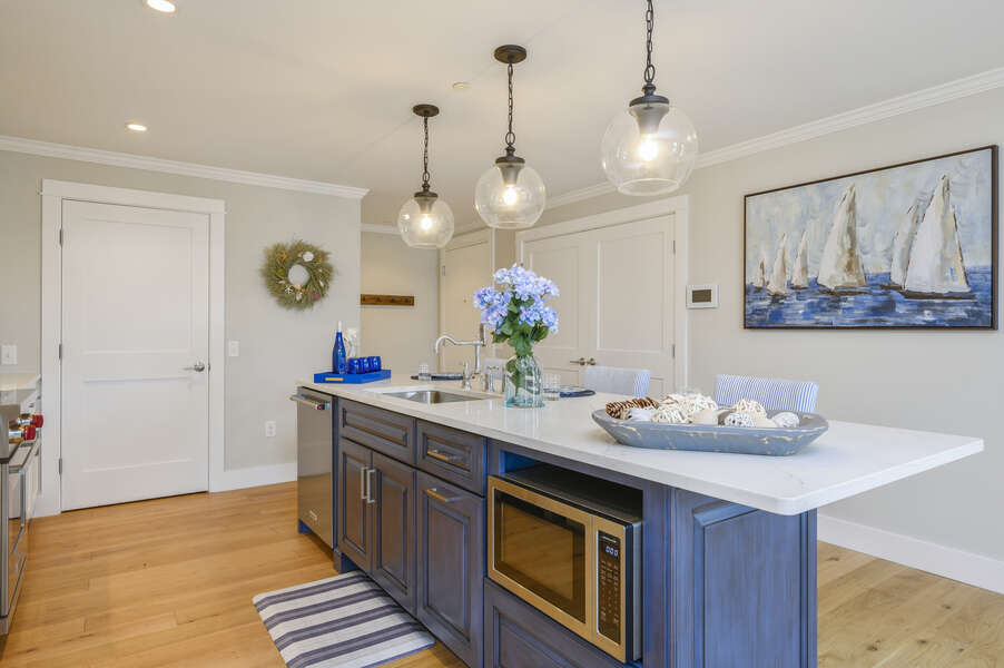 Large kitchen with island seating for 3 pantry closet and separate laundry is through the double doors. Unit 2, 557 Route 28, Harwich Port, Cape Cod, New England Vacation Rentals