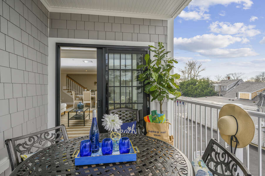 Private outdoor balcony entrance is off living room Unit 202 557 Route 28 Harwich Port Cape Cod New England Vacation Rentals