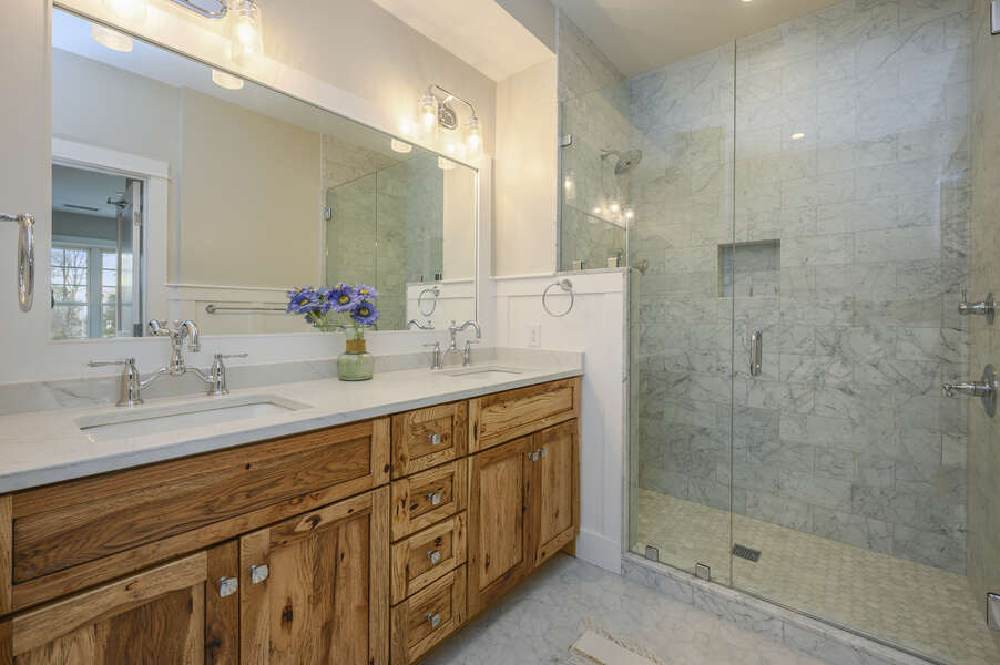 Bedroom 1, ensuite bathroom with double vanity and large walk in shower. Unit 204, 557 Route 28, Harwich Port, Cape Cod, New England Vacation Rentals