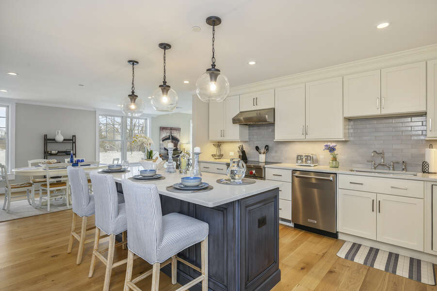 Luxury open concept kitchen with large center island with seating for 3 Dishwasher and chefs range. Unit 203, 557 Route 28, Harwich Port, Cape Cod, New England Vacation Rentals