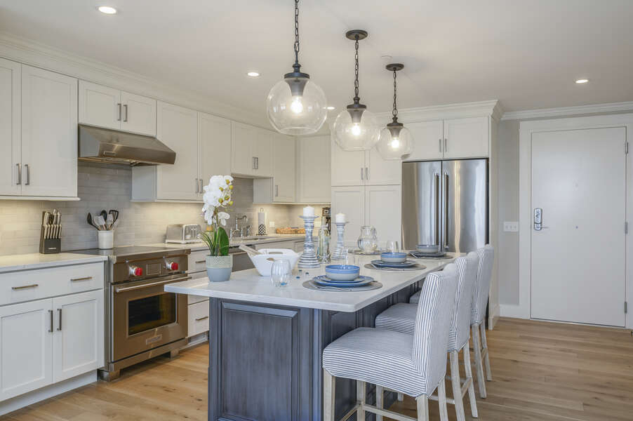 Large kitchen with center island stainless fridge and chefs range. Unit 203 557 Route 28, Harwich Port, Cape Cod, New England Vacation Rentals