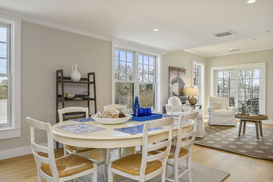 Open Concept dining and living area with seating for 6, 2 occasional chairs and entrance to private balcony. Unit 203, 557 Route 28, Harwich Port ,Cape Cod, New England Vacation Rentals
