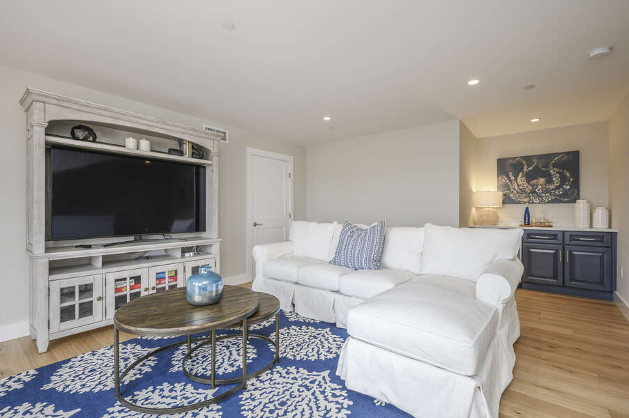 Bonus room with Large flat screen tv, comfy sectional and dry bar. Unit 203, 557 Route 28, Harwich Port, Cape Cod, New England Vacation Rentals
