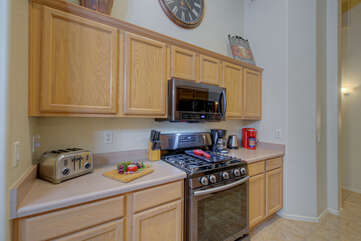 Kitchen has ample working and serving space plus the extra culinary tools that make the chef happy.