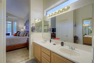 Bath adjoining primary suite has a large vanity with 2 sinks.