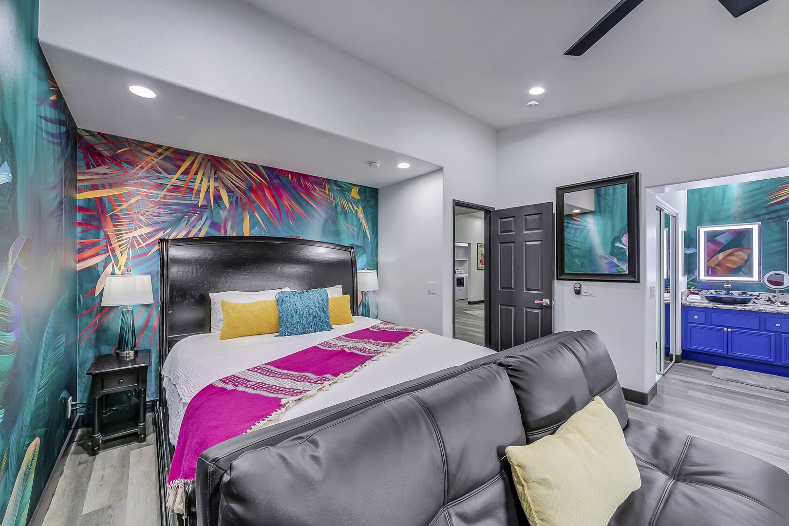 Master Suite 1 is located next to Casita Suite 3 features a Cal-King sized bed, 50-inch Roku television, remote-controlled ceiling fan, and private access to the back patio through the sliding glass door.
